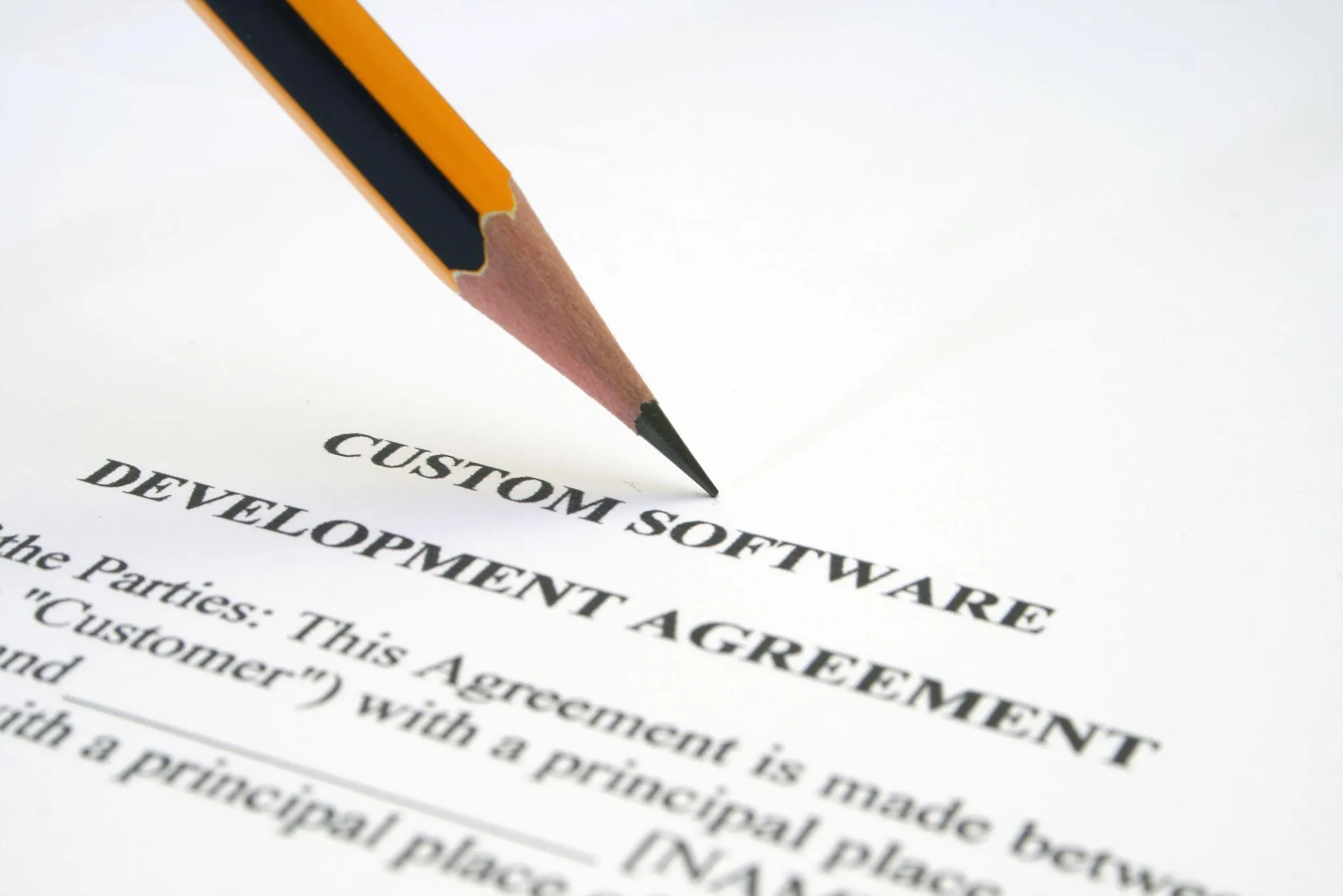Lawyer and product owner highlighting IP ownership clauses in a software contract draft